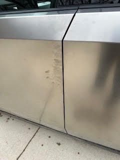 smudged side door of Tesla Cybertruck