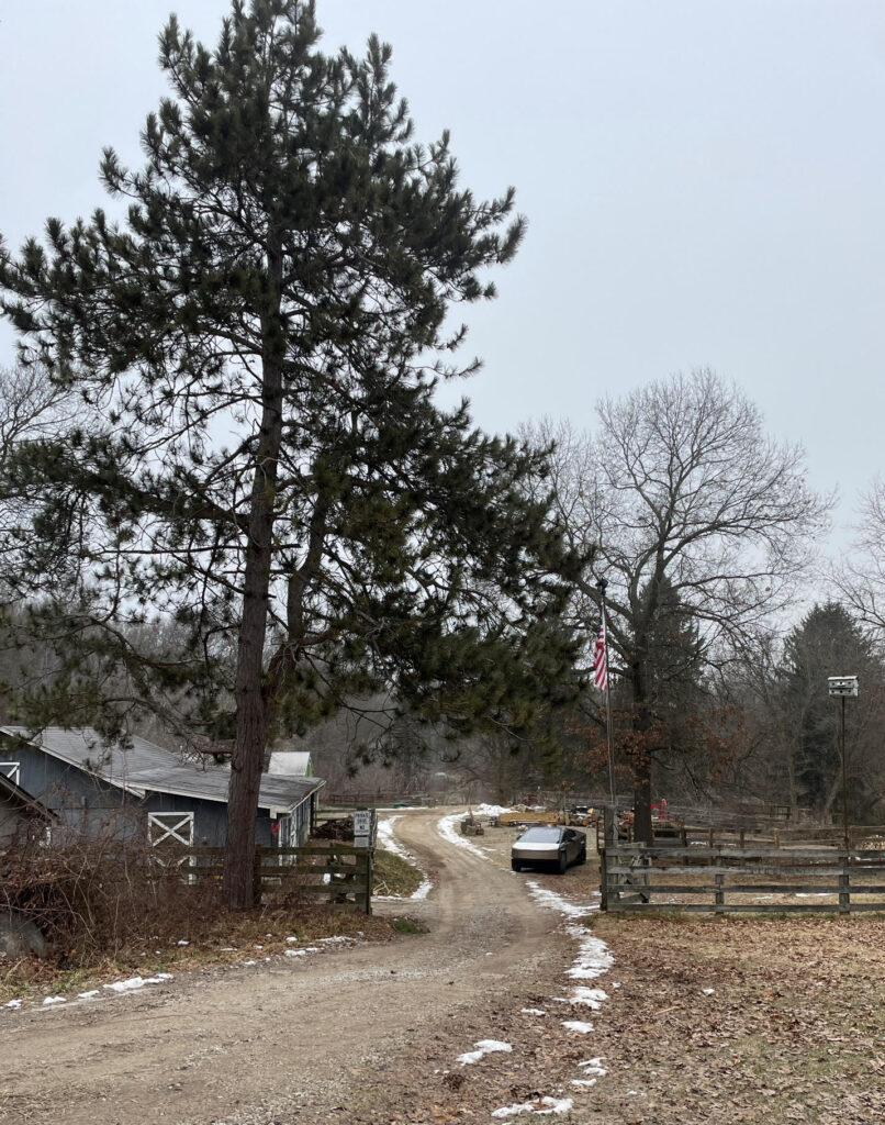 Tesla Cybertruck parked on a ranch.