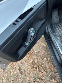 Tesla Cybertruck door with a water bottle inside.