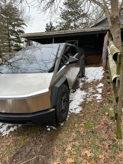Tesla Cybertruck parked on a steep hill.