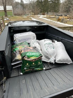 Feed and grain loaded on the back of a Tesla Cybertruck.