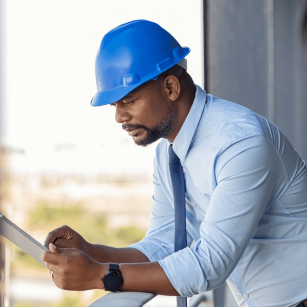 Male worker in hardhat using tablet computer - technical publications, localization services