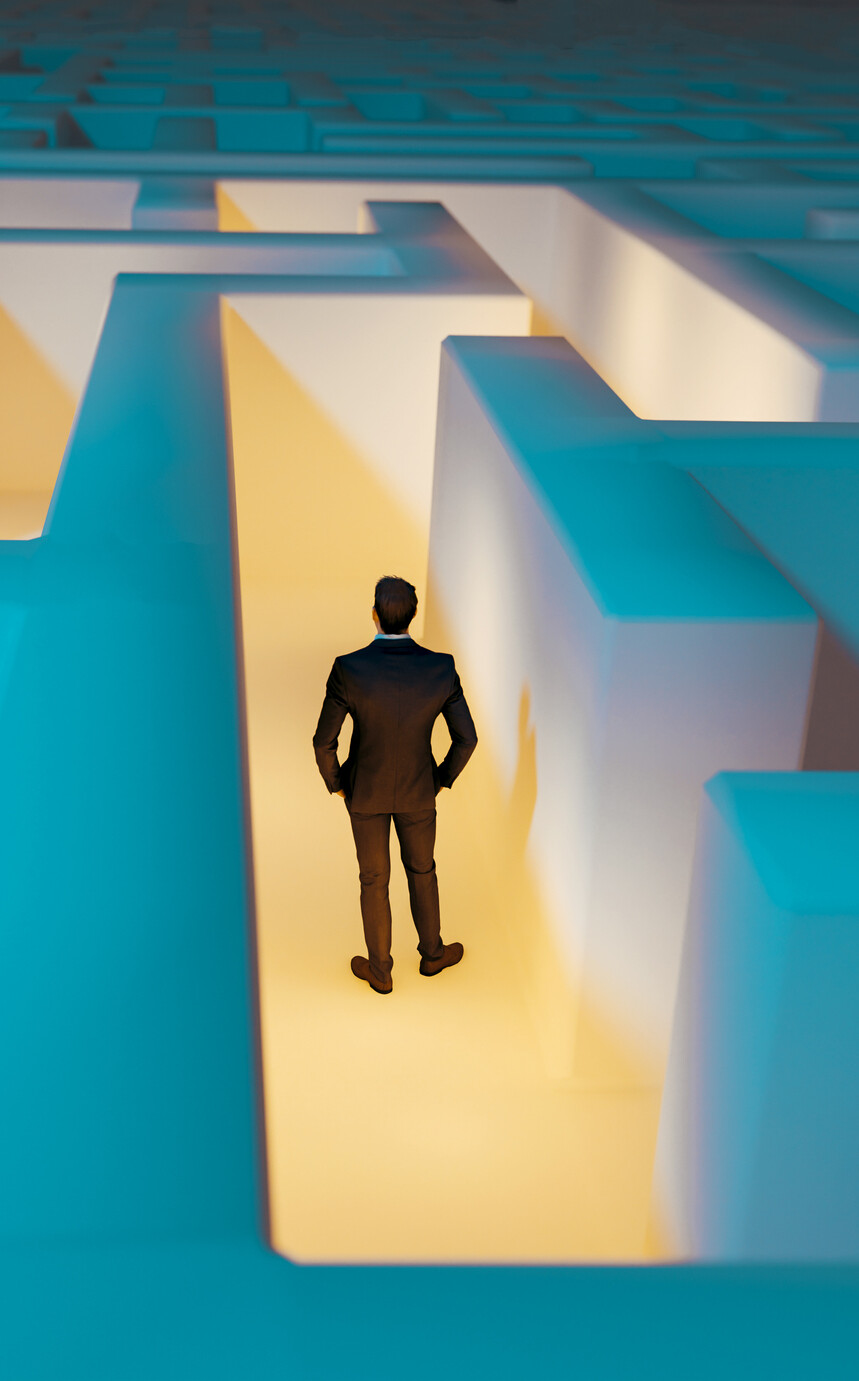 Man stands in the middle of dark maze. Lights guide the way for him. Concept of standing in front of a challenge and finding the right solution to move on.