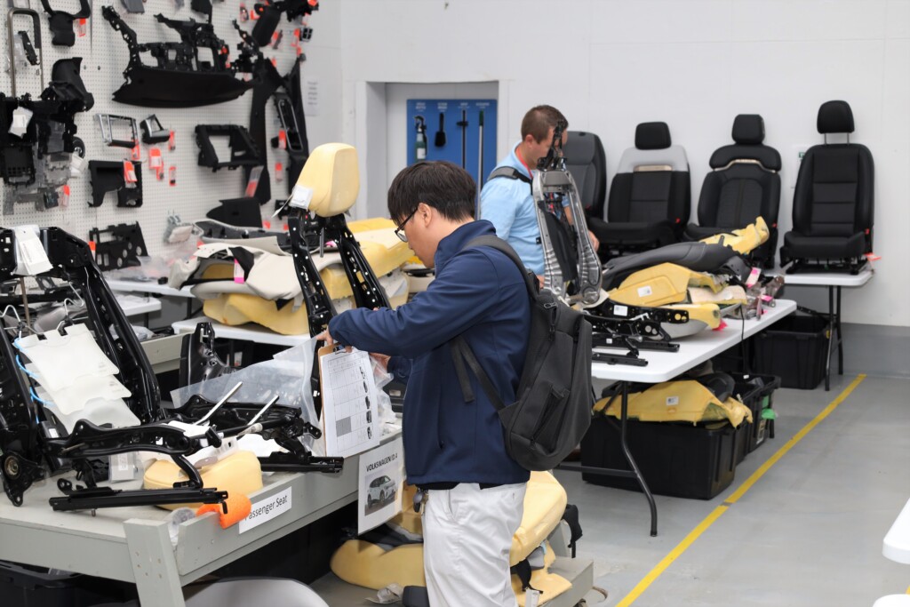 A man looking at parts for automotive benchmarking.
